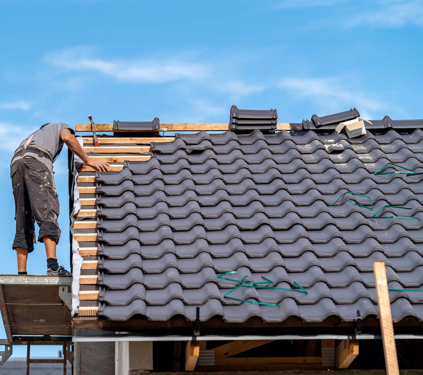 builder-on-the-roof-of-a-family-house-building-a-2023-09-09-04-36-44-utc