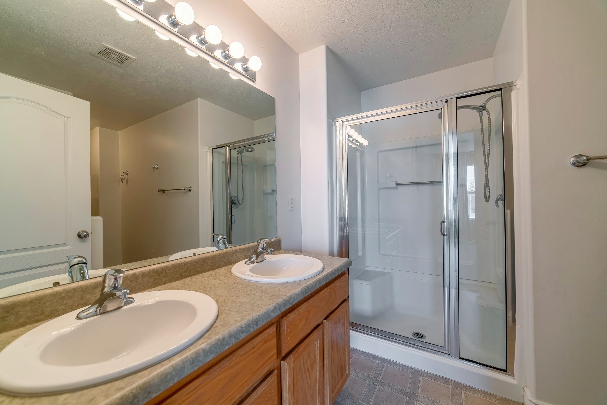 A minimalistic bathroom interior design in white color with a marble brown double sink