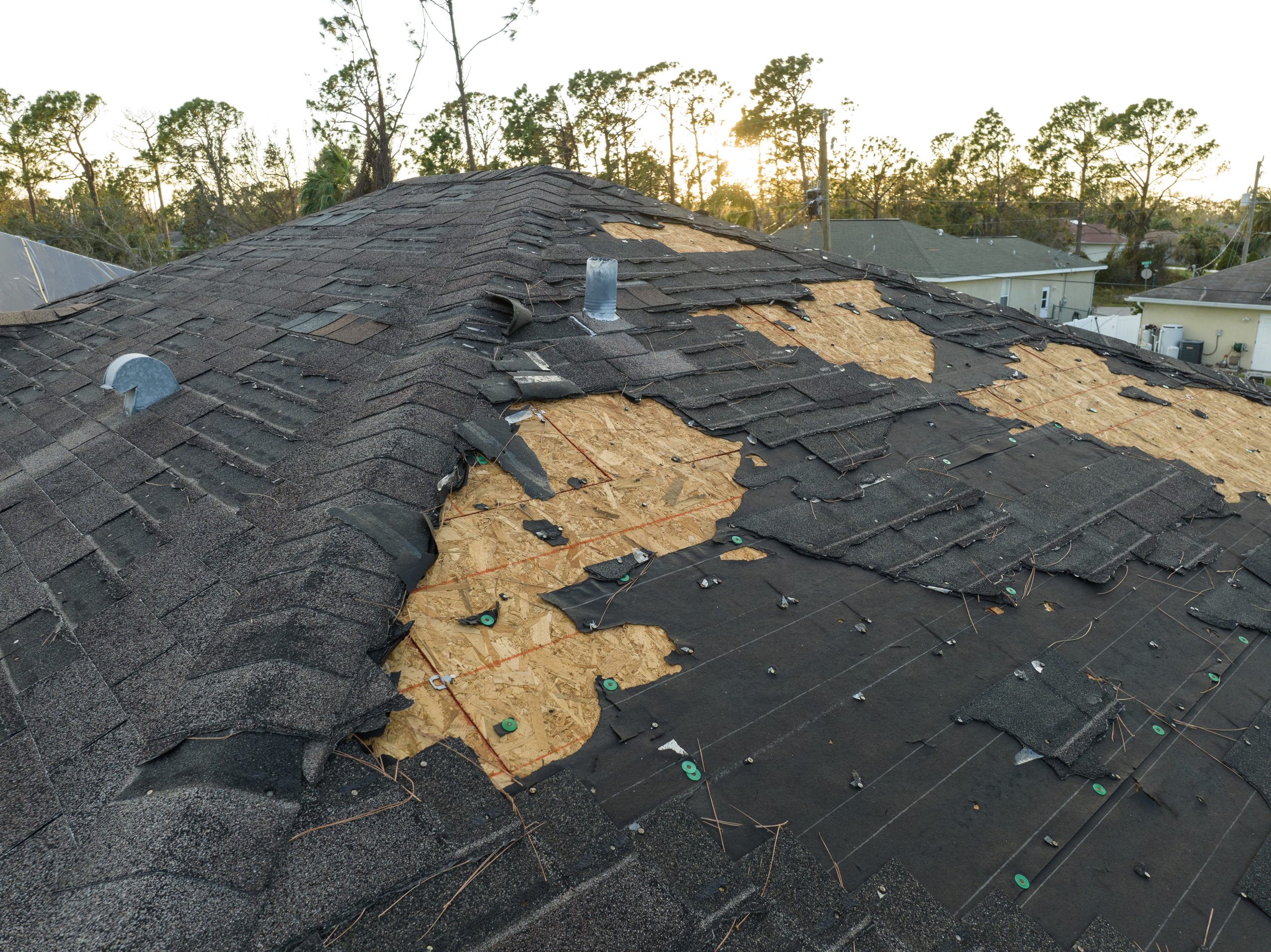 Natural disaster and its consequences. Hurricane Ian destroyed house roof in Florida residential area.