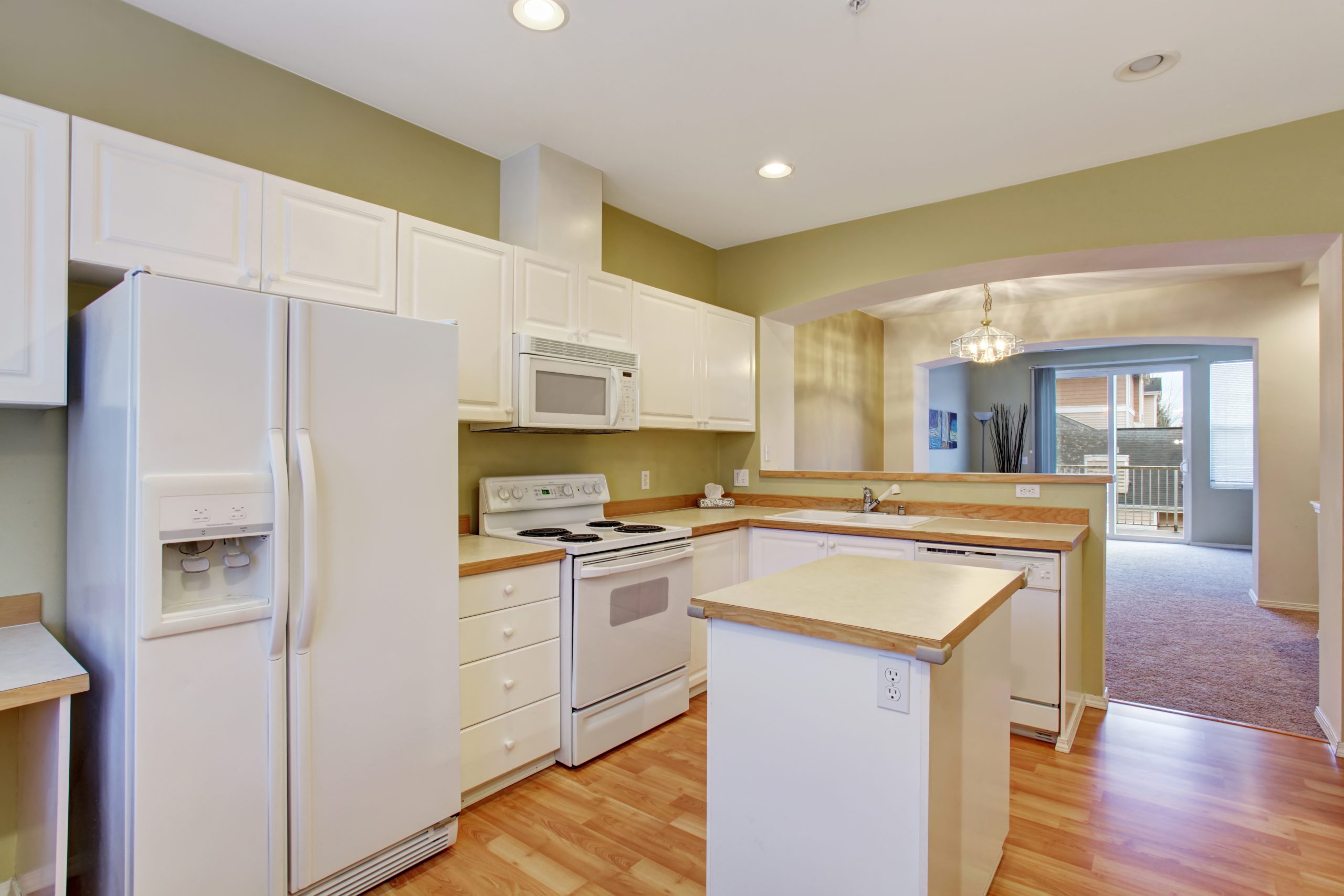 Modern kitvhen with hardwood floor, and island.